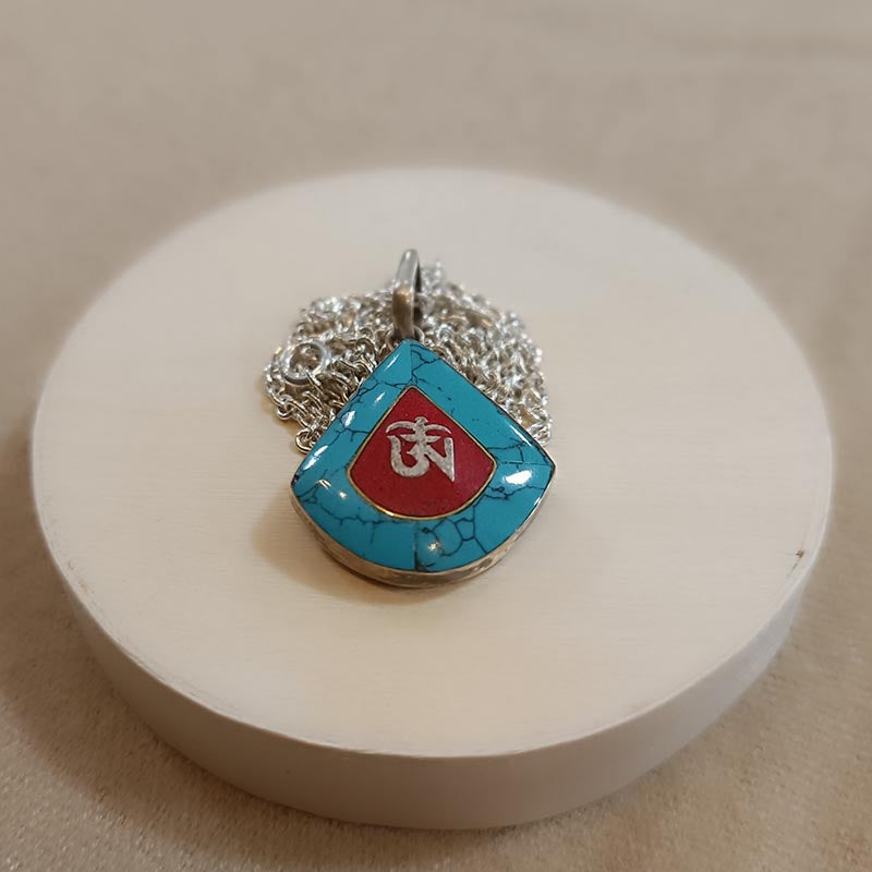 Colgante de plata y turquesa OM
